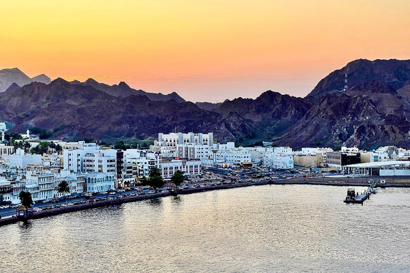 Coastal city and mountains at sunset in Oman